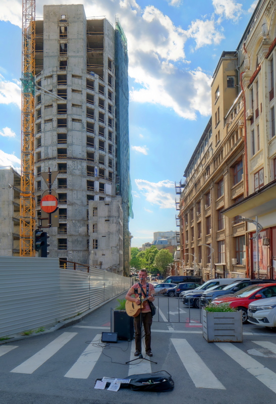 05 - Busker playing guitar near the demolition of the former Bancorex headquarters on Calea Victoriei in Bucharest